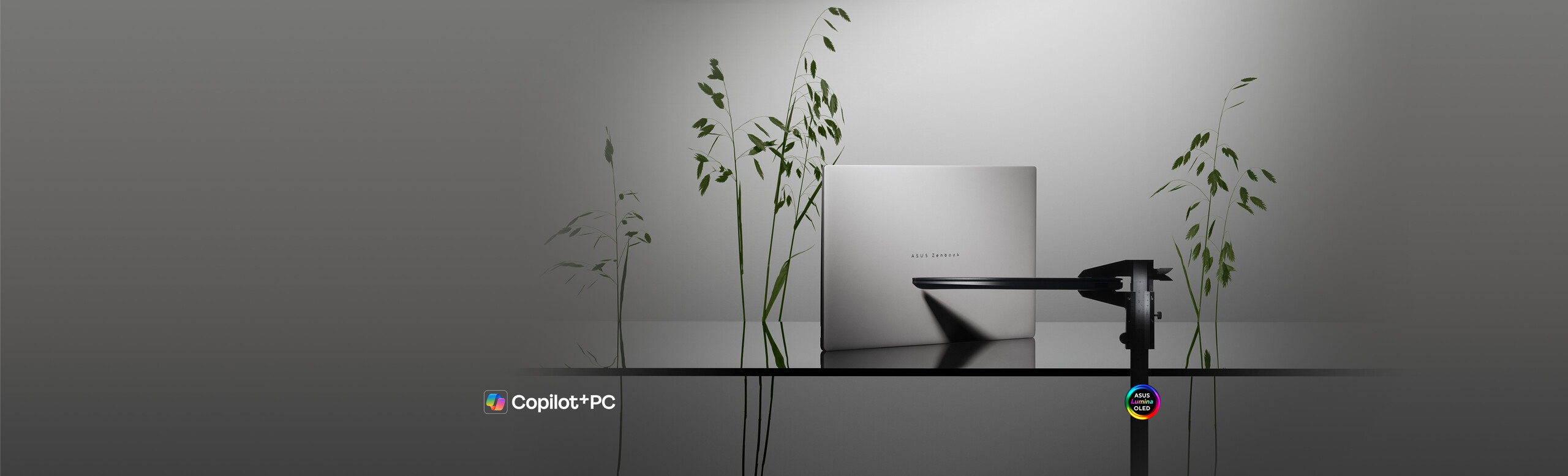 Two white ASUS Zenbook S14 laptops are shown in the picture. One is placed vertically on a glass surface, showing the chassis cover, while the other is fixed in a caliper, showing the side silhouette. Some green slim plants are adorned in the background.